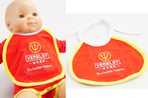 Custom baby bib displayed on doll